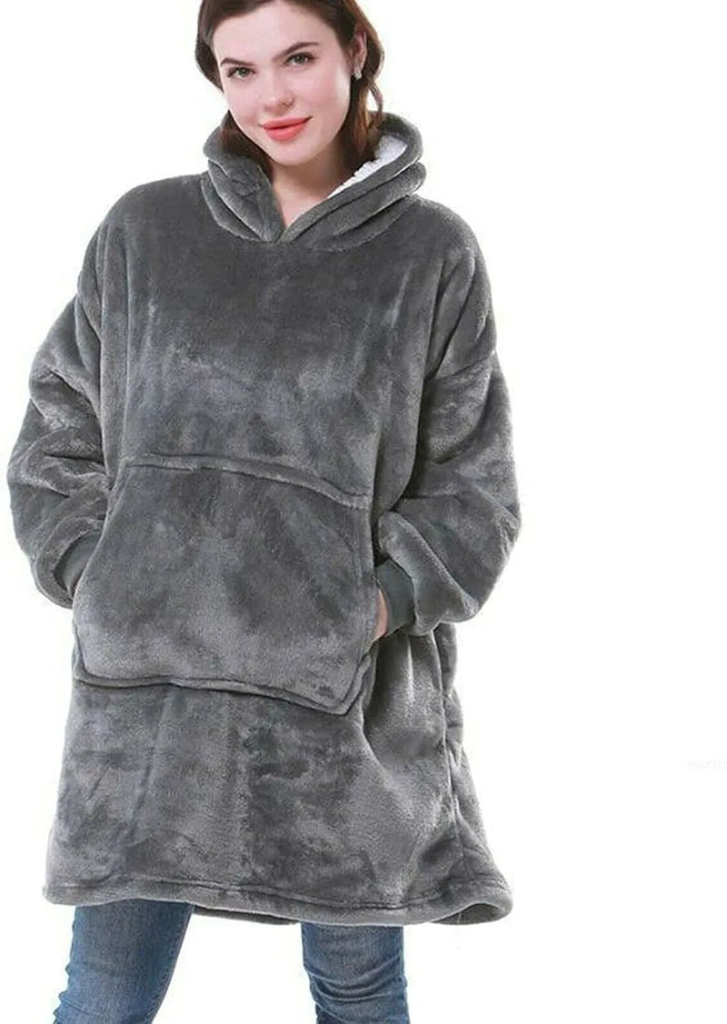Person wearing a gray fleece blanket hoodie on a white background